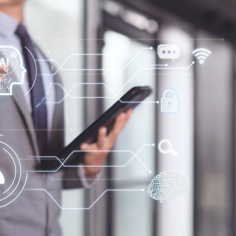 Businessman interacting with artificial intelligence. Automation and optimization technology.